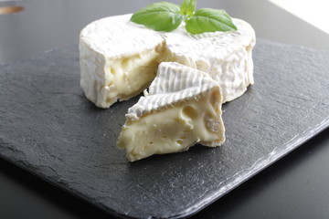 Camembert brie cheese on a stone background