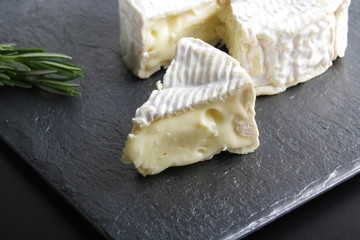 Camembert brie cheese on a stone background