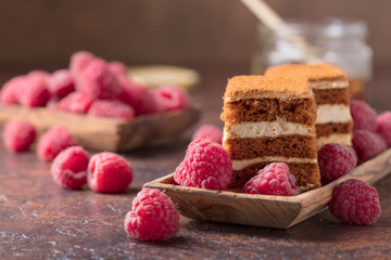 Layered honey cake with cream and raspberries.
