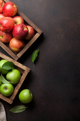 Green and red apples in wooden box