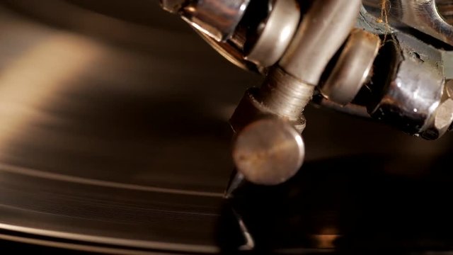 Macro of needle and vinyl at old retro gramophone plays music