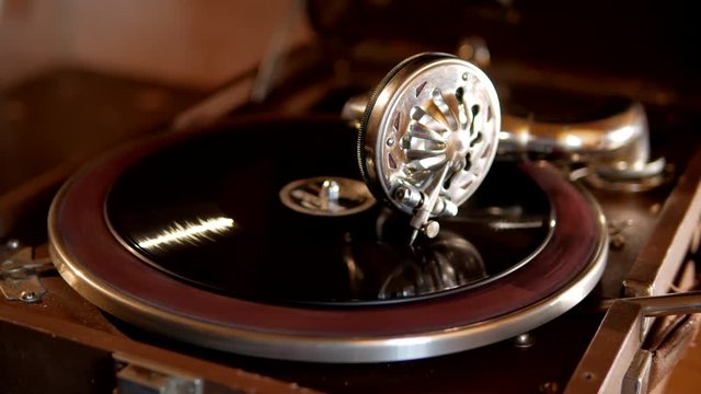 Old grandfather gramophone plays dance music records from vinyl