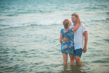 Woman hugging a man standing in the water