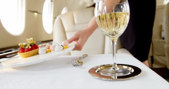 Flight attendant serving sweet food in private jet 4k