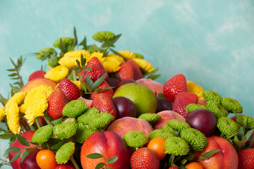 a beautiful bouquet of fruits and flowers for the birthday of strawberries grape peaches