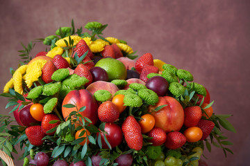 a beautiful bouquet of fruits and flowers for the birthday of strawberries grape peaches