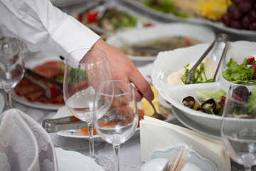 Businessman hands taking food in buffet line indoor in luxury hotel