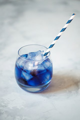 Butterfly pea drink with ice in glass