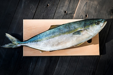 Raw fish tuna on a wooden table, free space.