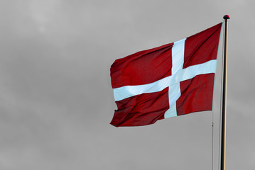Danish flag in front of grey sky