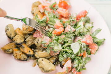 Fried mussels with fresh vegetable salad.