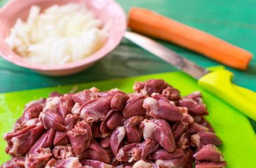 Fresh raw chicken hearts cut for preparation.