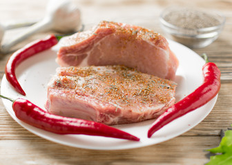 Raw pork ribs with hot red pepper. Preparation of meat for grilling.