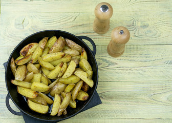 Fried potatoes in a frying pan.