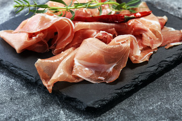 Italian prosciutto crudo or jamon with parsley. Raw ham