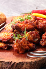 barbecue chicken wings close up on wooden tray