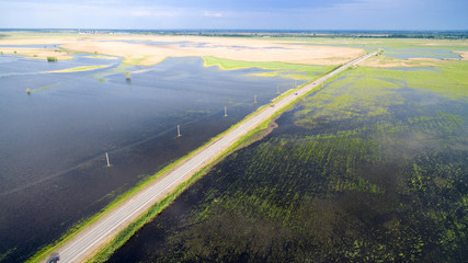 Road through flooded fields