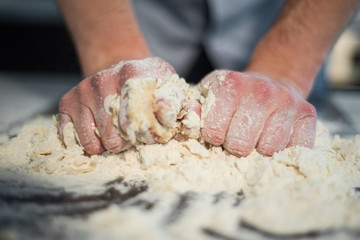 a man prepares the dough