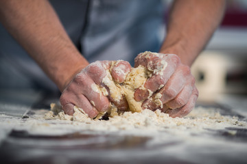 a man prepares the dough