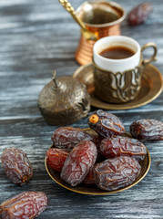 Dates on the plate, copper cezve and black coffee.