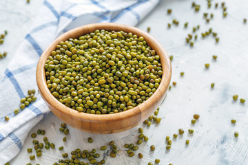 Green mung beans in a wooden bowl.