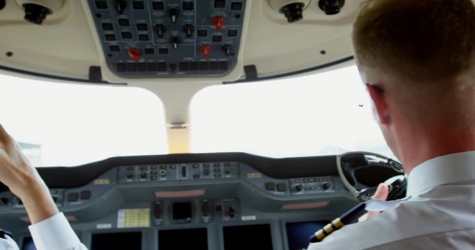 Two male pilots ready to take off private jet 4k