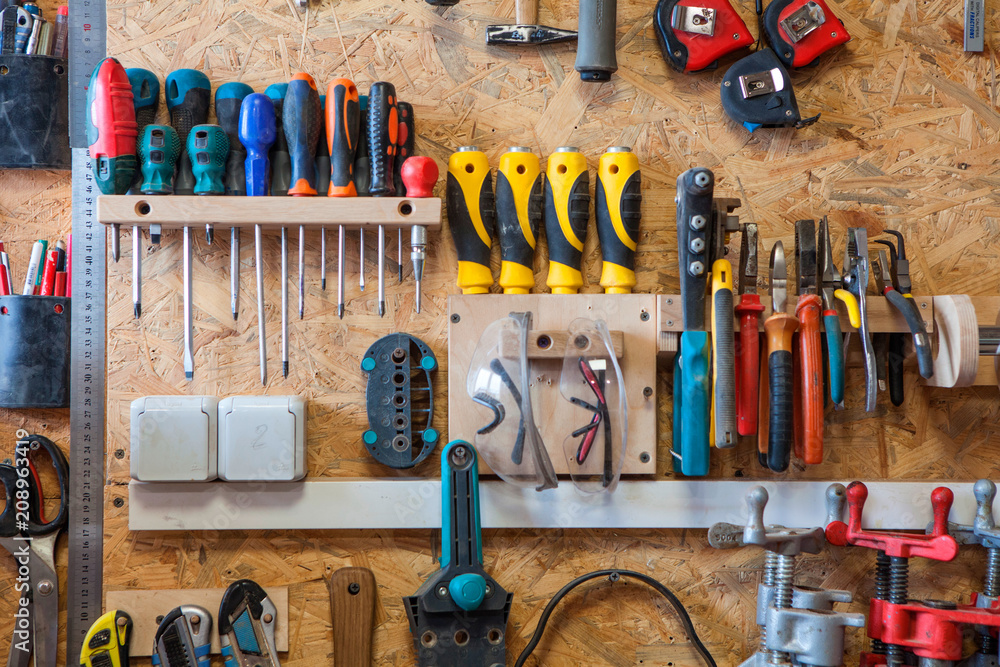 Wall mural workshop of wood with a large amount of instruments and tools.