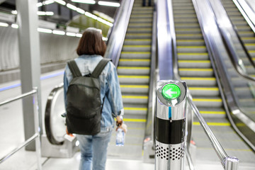A woman with a backpack approaches the escalator in the Budapest subway