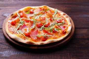 Italian pizza with prosciutto and arugula,