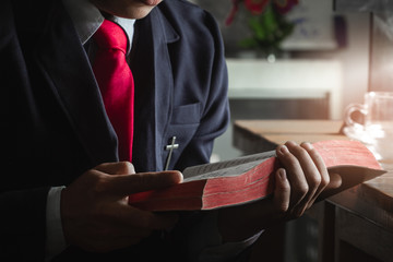 Young man reading and studying the bible.