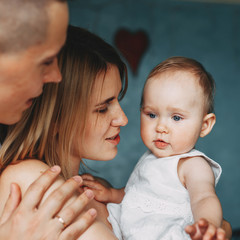 Family of mom, dad and baby, close up portrait