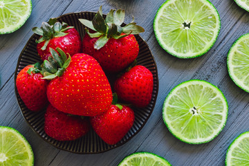 Fototapeta na wymiar Bright Red Strawberries and Limes