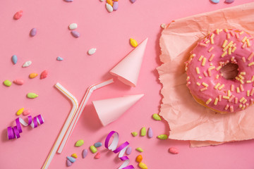 Sprinkled Pink Donut. Frosted sprinkled donut on pink background.