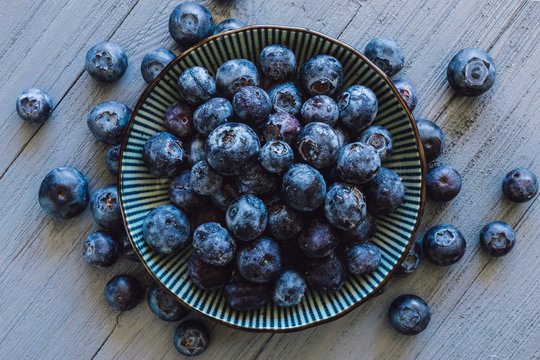 Centered Bowl of Blueberries with Scattered Berries