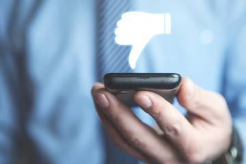 Man holding dislike icon. Social media concept