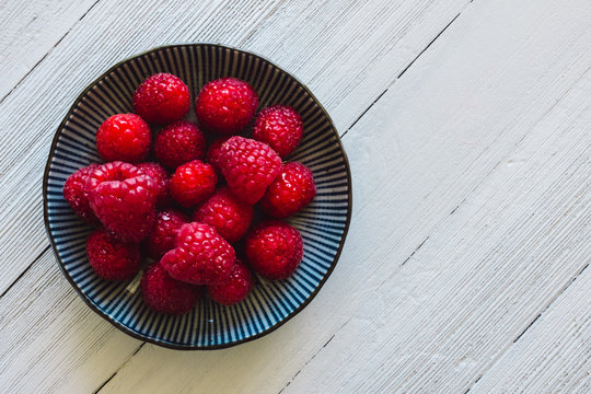 Bowl of Raspberries on White Table