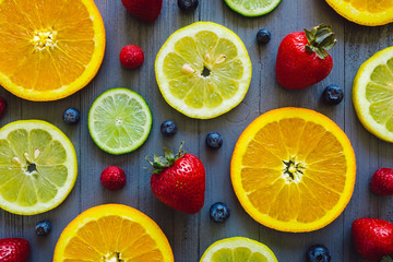 Mixed Sliced Citrus with Berries on Blue Table