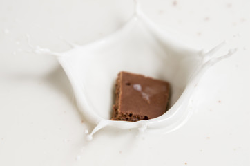 Chocolate falls in milk