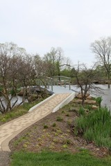 Fototapeta na wymiar The walkway up to the wood bridge over the pond in park.