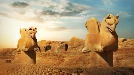 Sculptures of griffins in ancient Persepolis against the backdrop of the rising sun. Iran. Ancient...