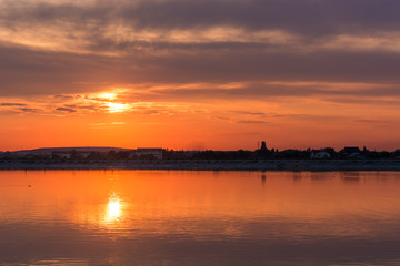 Fototapeta na wymiar A Quiet Orange Sunset at the Lake