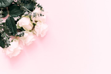 Flowers composition. Border of flowers roses on a pink background. Flat lay, top view, copy space 