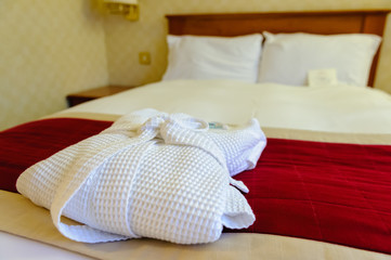 Fototapeta na wymiar Dressing gown on a hotel bed