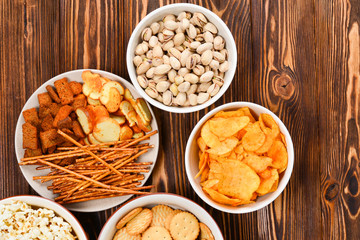 Snacks on a wooden background. Space for text or design.