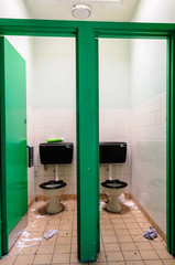 Pair of messy toilets with litter