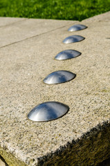 Obraz premium Anti-skateboarding devices installed on a low stone wall