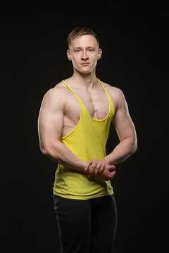 beautiful bodybuilder in t-shirt posing on black background