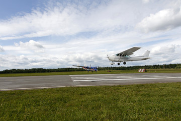 Fototapeta premium Small white airplane is landing