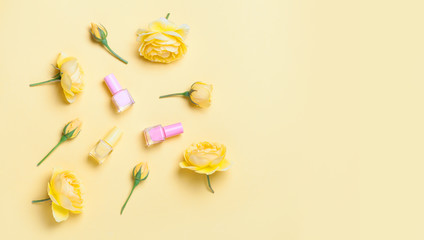 Nail polish bottle and yellow roses