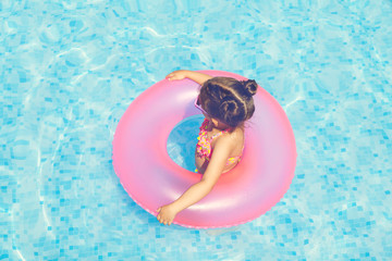 Cute and funny girl in swimming pool